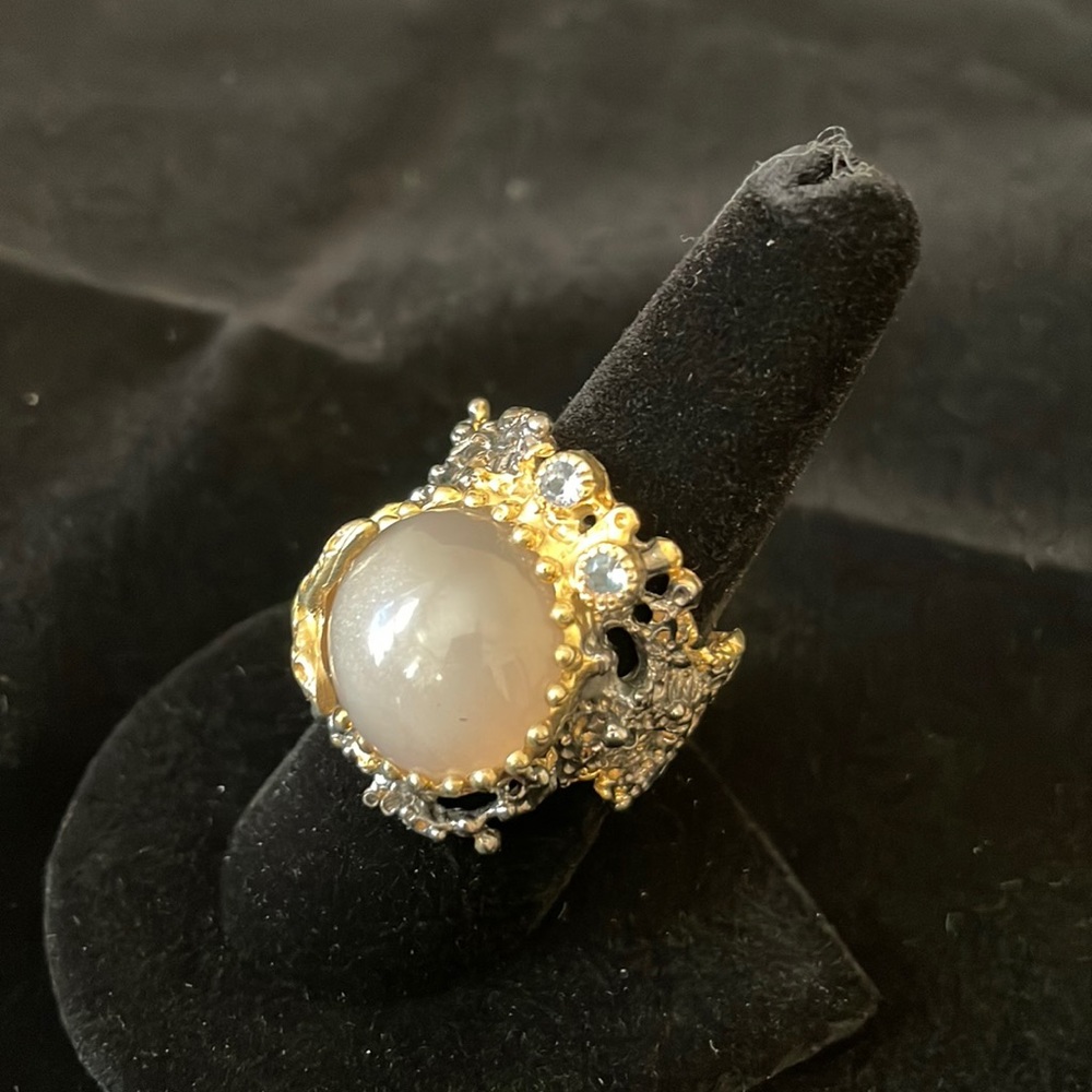 Silver ring with rose quarts, two blue gemstone accents and gold starfish.